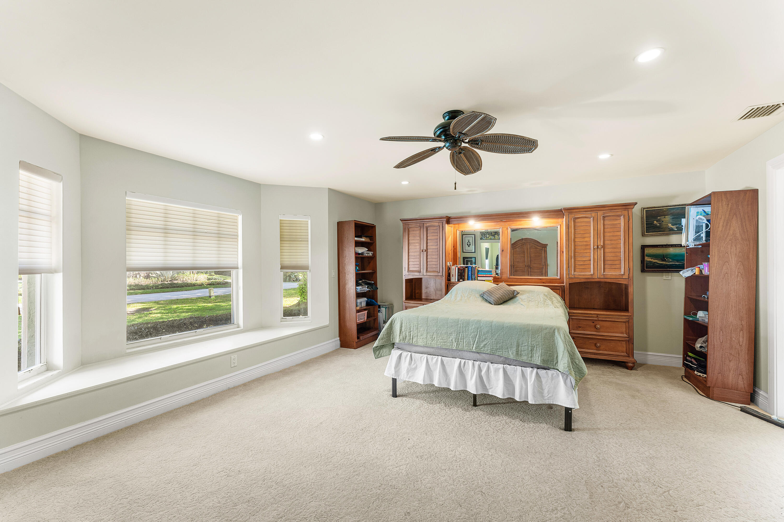 10295 St Andrews Road Boynton Beach, FL 33436 - Photo 22 of 43 a spacious bedroom with a large bed and a large window