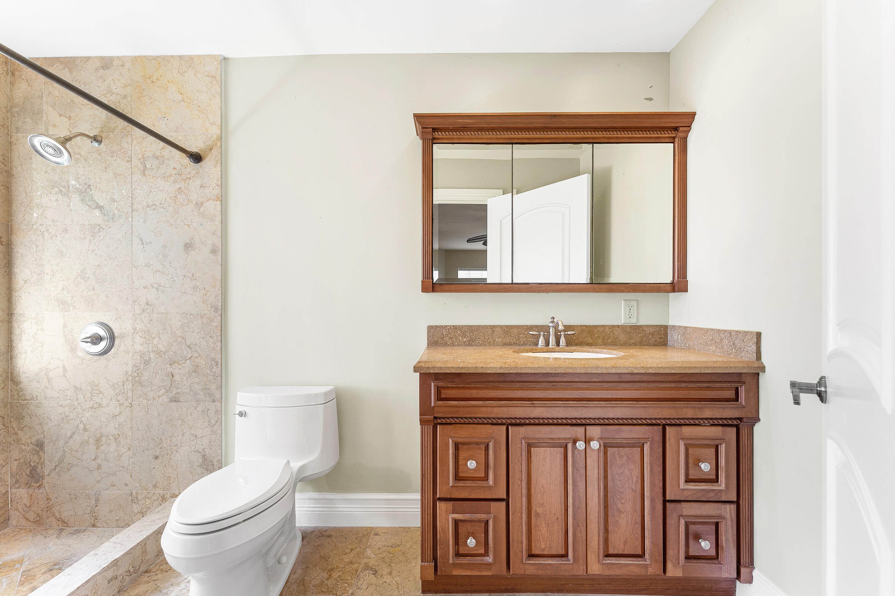 10295 St Andrews Road Boynton Beach, FL 33436 - Photo 23 of 43 a bathroom with a toilet a sink and a mirror