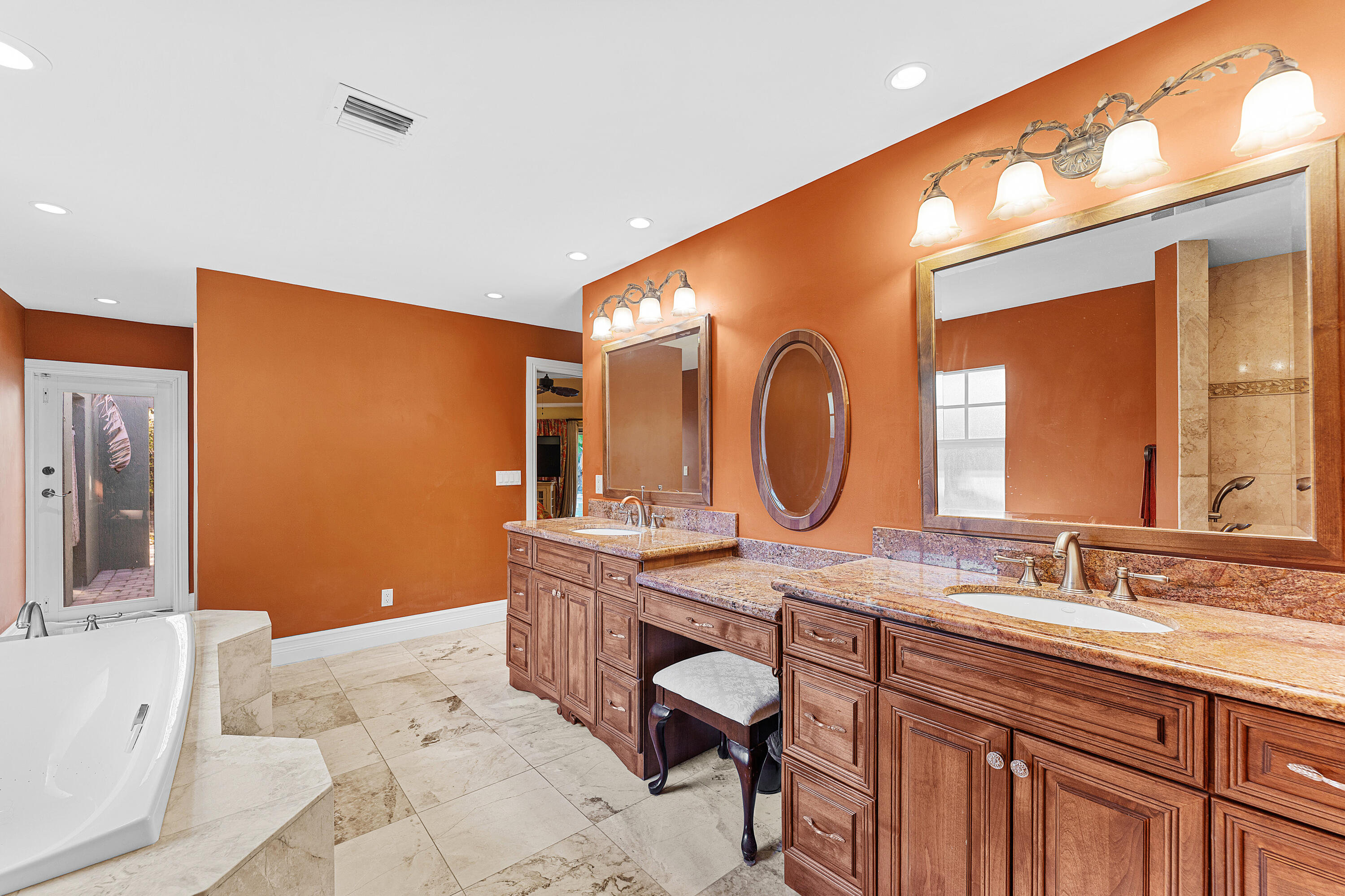 10295 St Andrews Road Boynton Beach, FL 33436 - Photo 24 of 43 a bathroom with a granite countertop sink a mirror and a bathtub