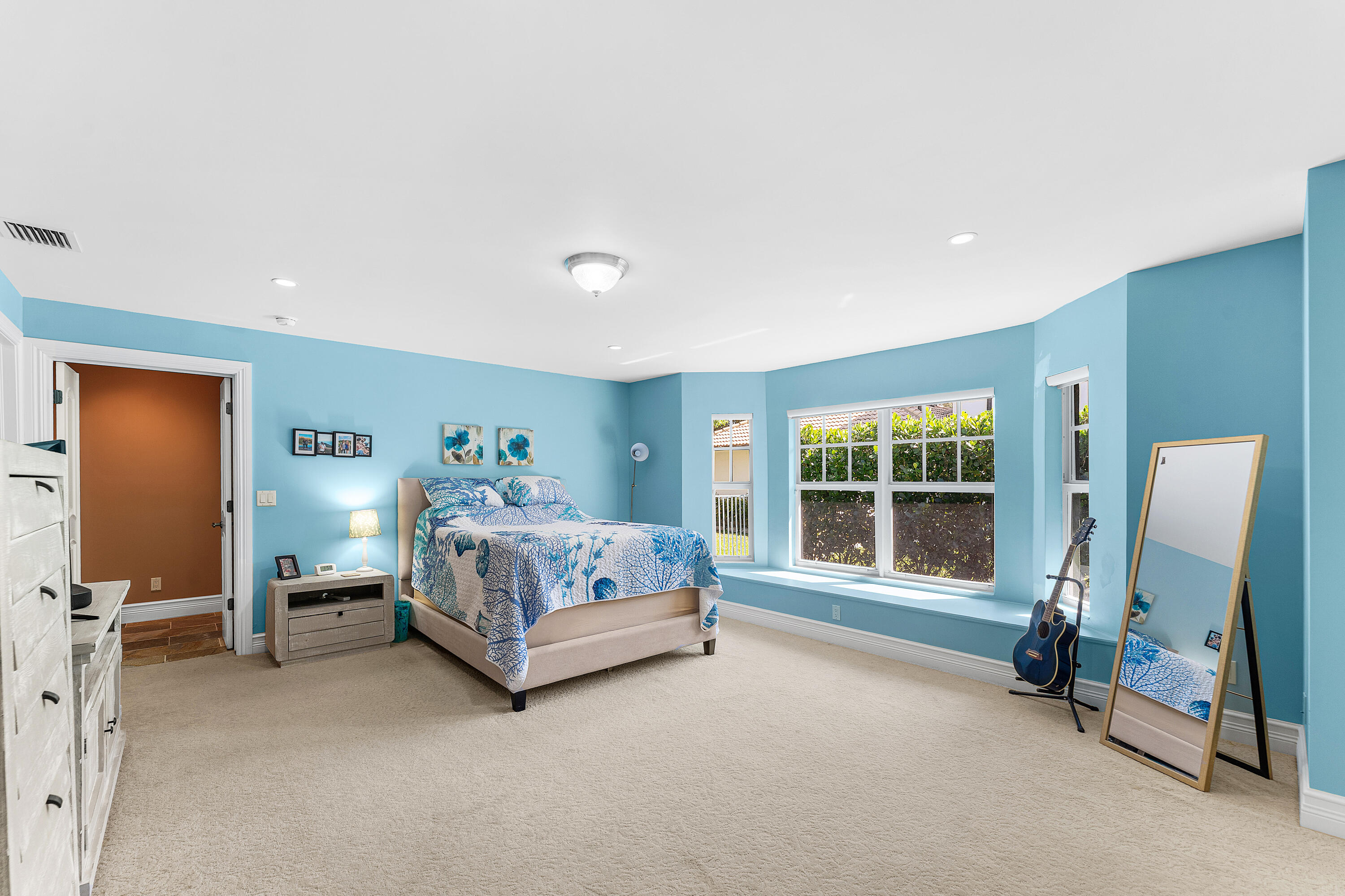 10295 St Andrews Road Boynton Beach, FL 33436 - Photo 25 of 43 a bedroom with a bed and large mirror