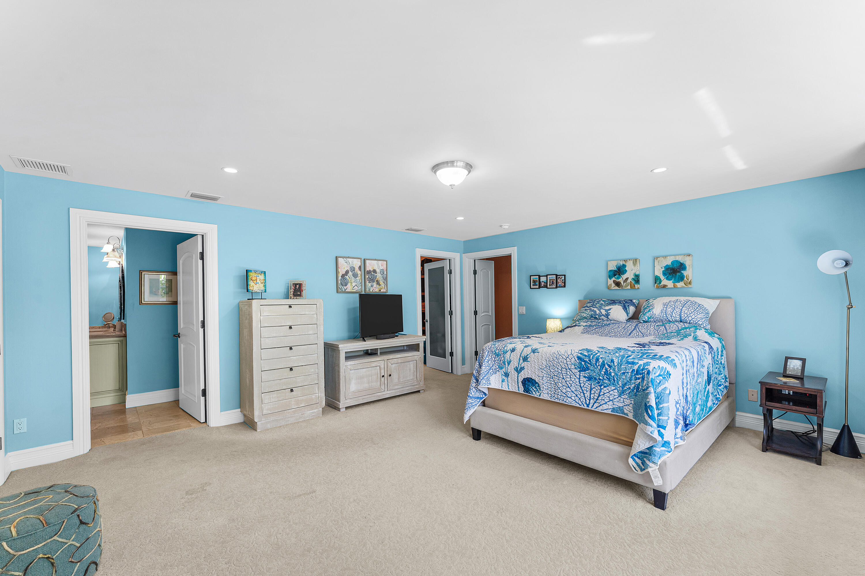 10295 St Andrews Road Boynton Beach, FL 33436 - Photo 29 of 43 a spacious bedroom with a bed and a flat screen tv
