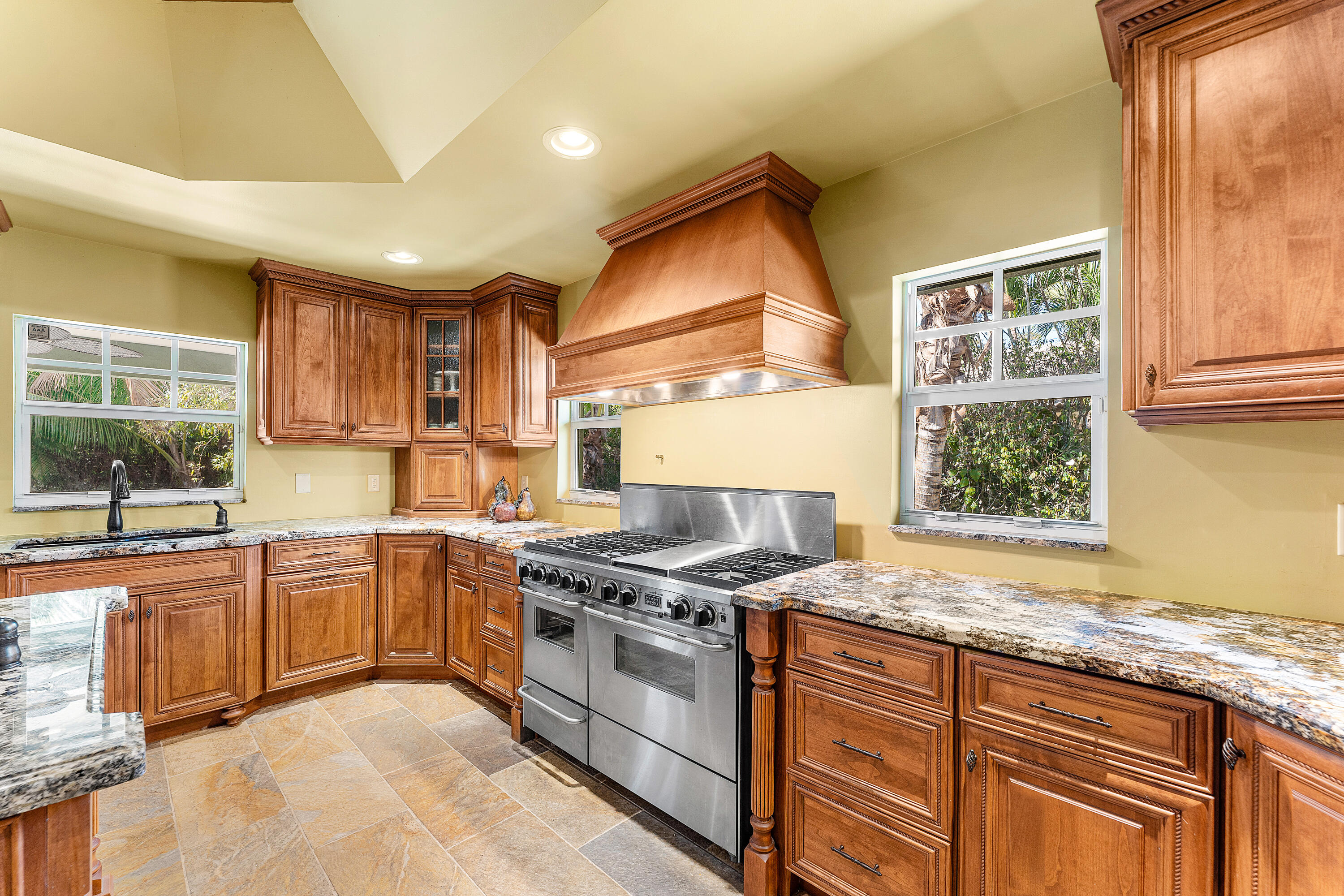 10295 St Andrews Road Boynton Beach, FL 33436 - Photo 9 of 43 a kitchen with stainless steel appliances granite countertop hardwood floor sink stove and granite counter top