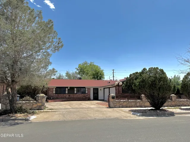 a view of a house next to a yard and road