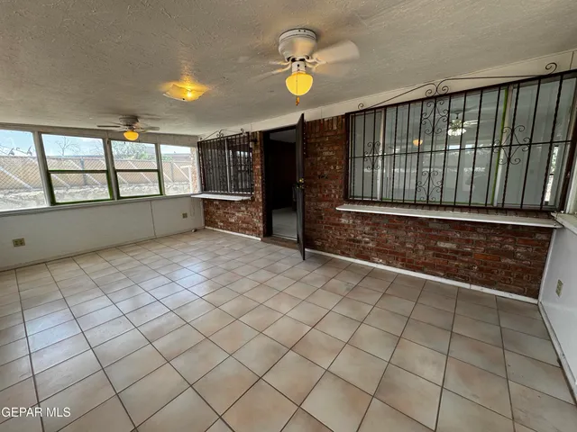 a kitchen with stainless steel appliances granite countertop a dining table and chairs