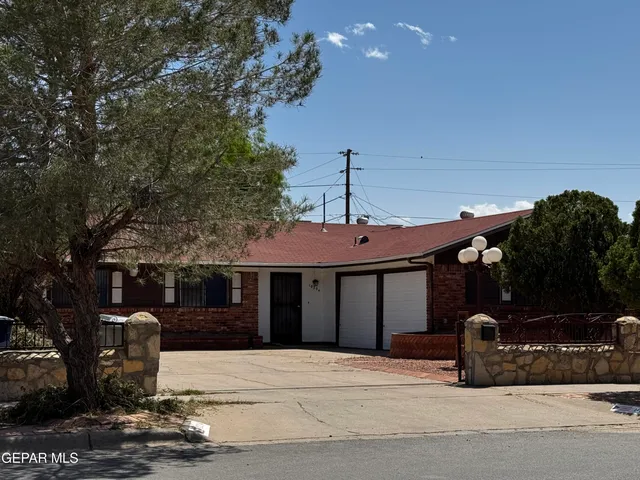 a front view of a house with parking area