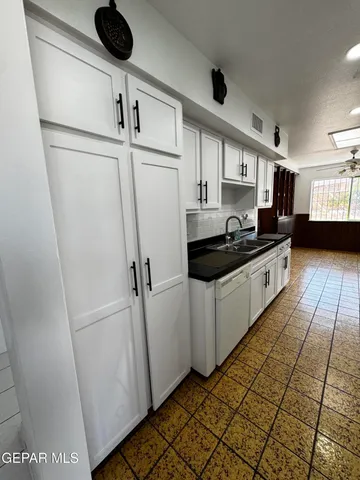 a kitchen with stainless steel appliances a refrigerator sink and cabinets
