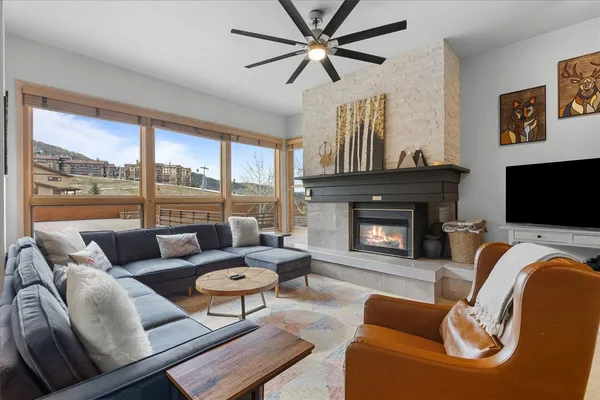 a living room with furniture and a fireplace