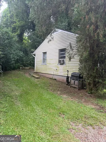 a view of backyard with outdoor seating and green space