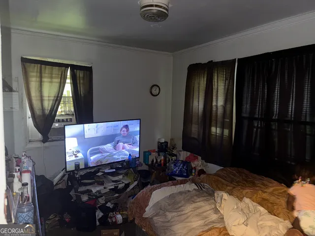 a room with bed mirror and window