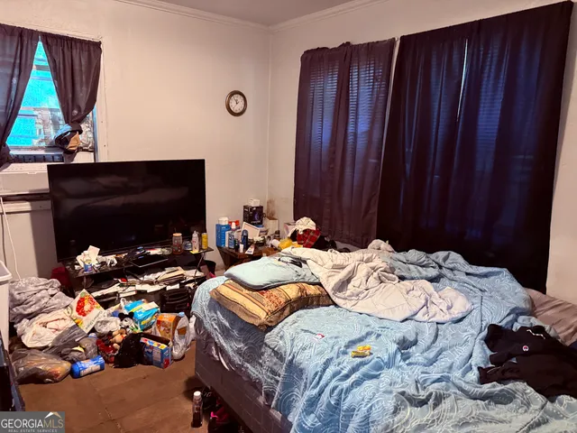 a bedroom with bed and a tv