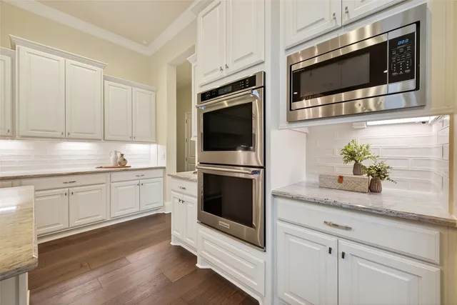 a living room with furniture wooden floor and a large window
