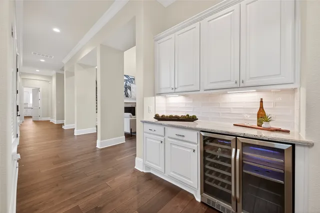 a media room with lots of chairs and wooden floor