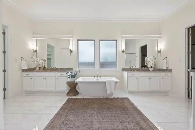 a view of a house with table and chairs in the patio