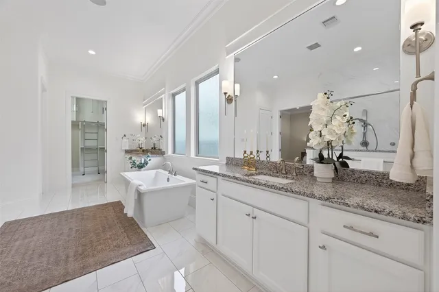 a spacious bedroom with a bed couch and a window