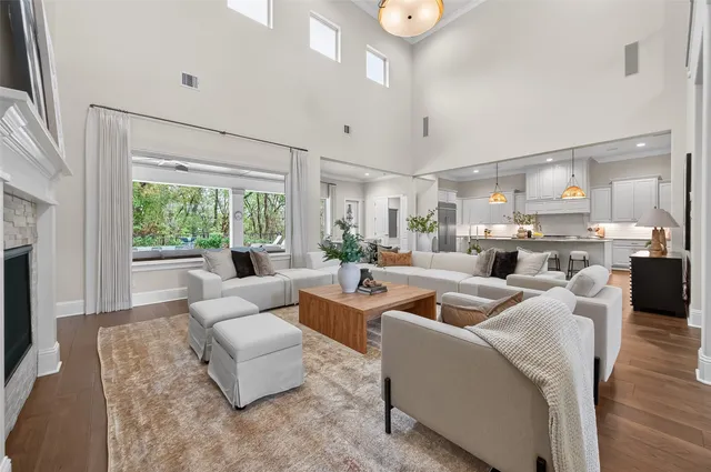 a kitchen with granite countertop cabinets stainless steel appliances wooden floor and a window