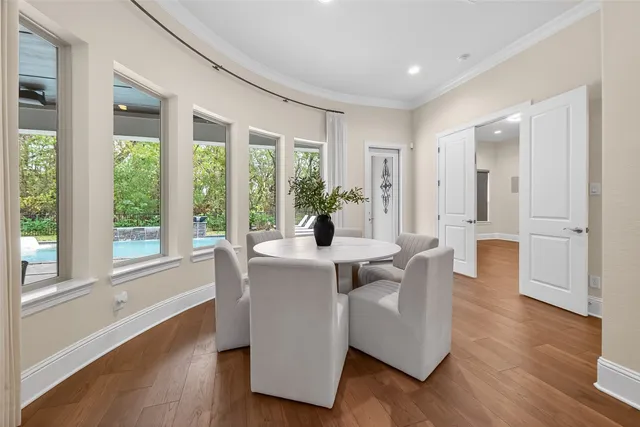 a view of a white house with a big yard and potted plants
