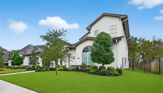 a kitchen with granite countertop white cabinets stainless steel appliances and wooden floor