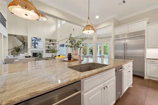 a spacious bathroom with a granite countertop sink a mirror and a bathtub
