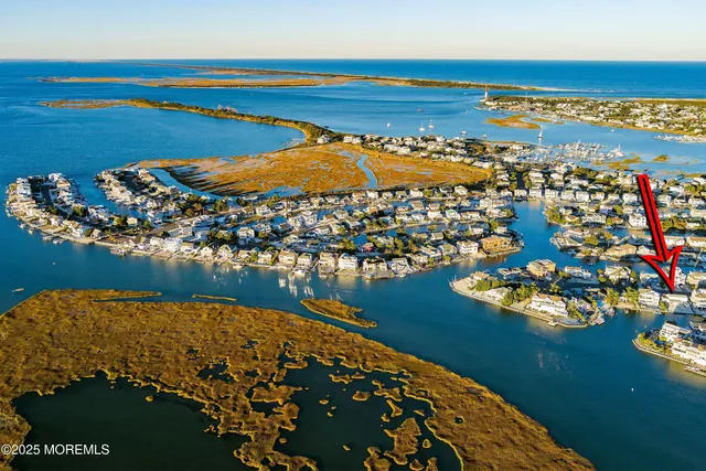a view of a lake with a table and chairs