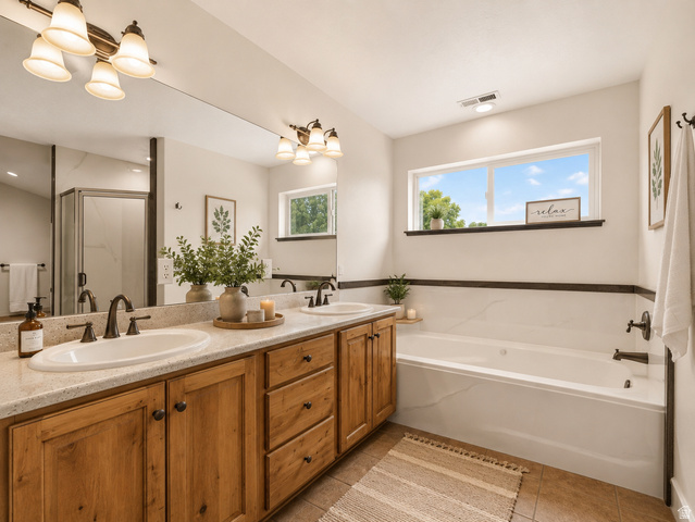 1279 West 1500th Street North Mapleton, UT 84664 - Photo 50 of 93 Dual vanity with undermount sinks and bronze-finish faucets, set beneath a large mirror and multi-bulb light fixture