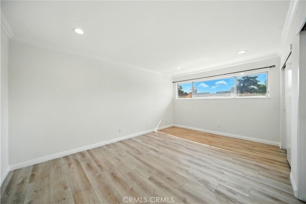 471 West Duarte Road, Unit 216 Arcadia, CA 91007 - Photo 12 of 18 a view of an empty room with wooden floor and a window