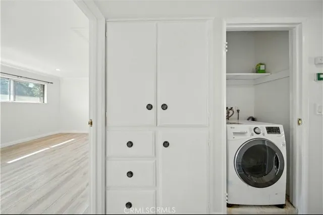 a view of a hallway with washer and dryer
