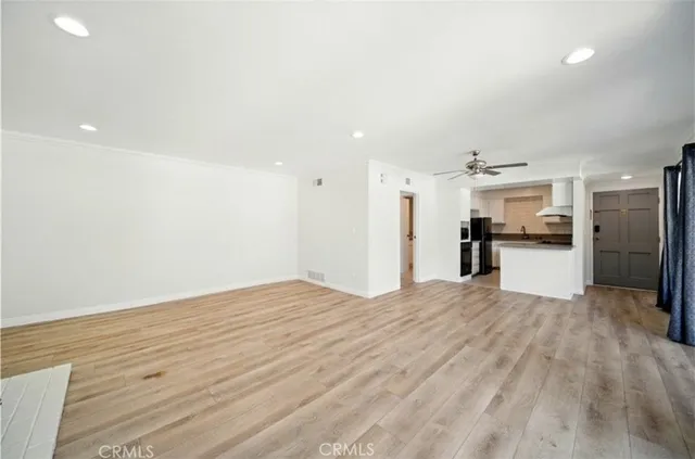 a view of a kitchen with a refrigerator and a sink