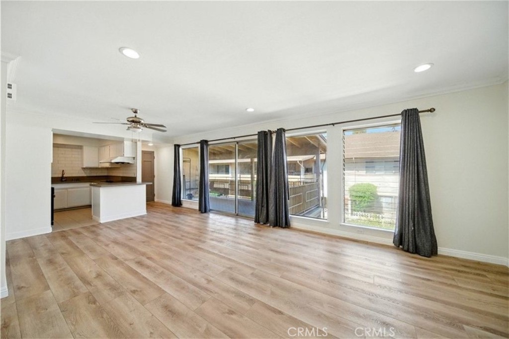 471 West Duarte Road, Unit 216 Arcadia, CA 91007 - Photo 4 of 18 a view of an empty room with a window and wooden floor