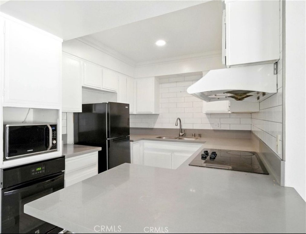471 West Duarte Road, Unit 216 Arcadia, CA 91007 - Photo 6 of 18 a kitchen with a sink a microwave a stove and refrigerator