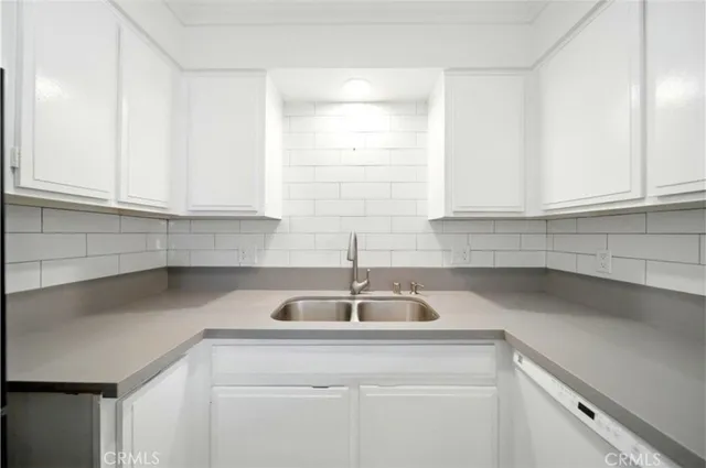 a kitchen with a sink and cabinets