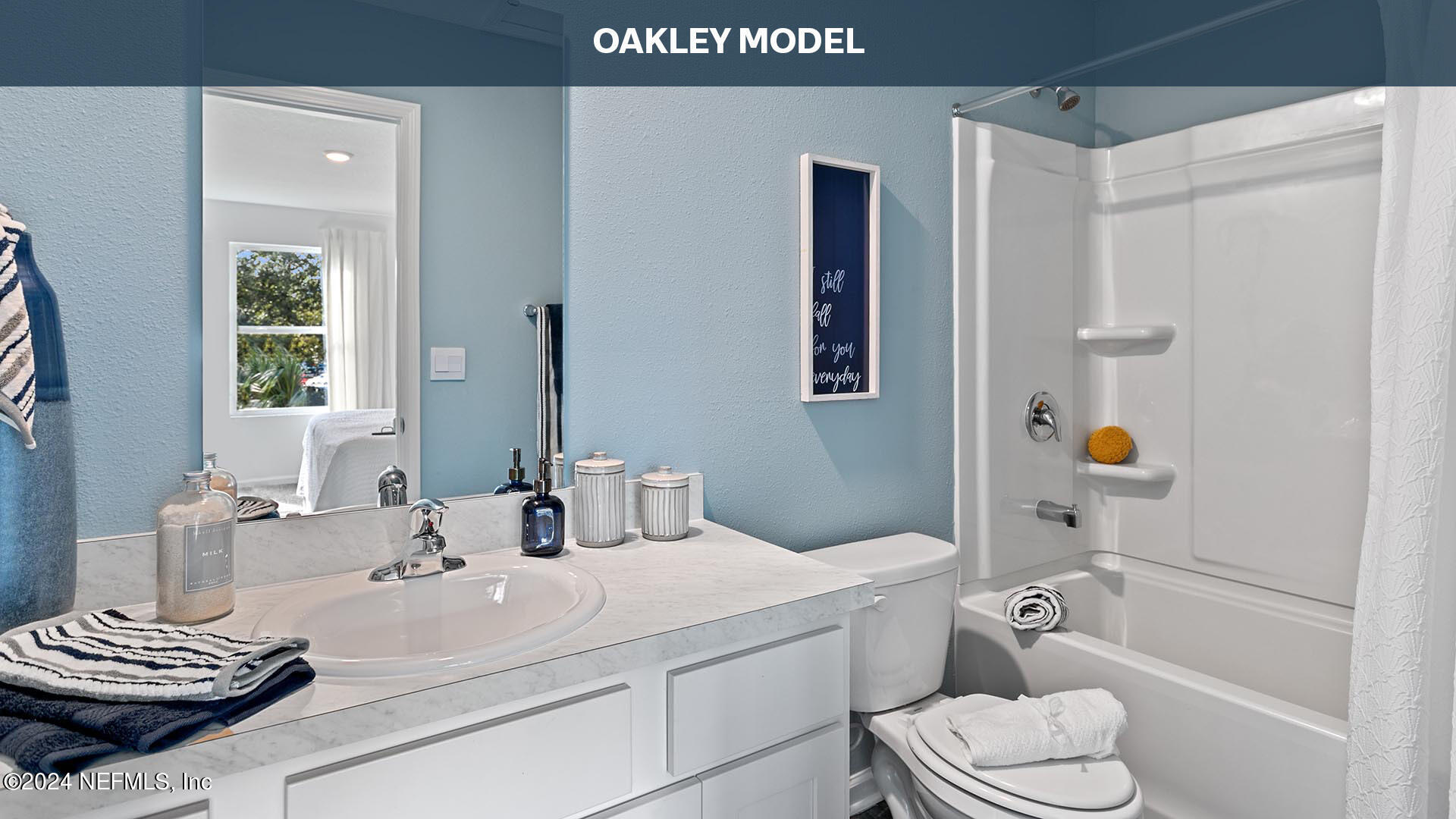 9249 Stony Brook Road Jacksonville, FL 32256 - Photo 12 of 34 a bathroom with a sink a toilet and shower curtain