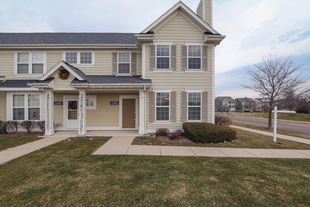1240 Mariemont Road, Unit E Sugar Grove, IL 60554 - Photo 1 of 32 a front view of a house with a yard