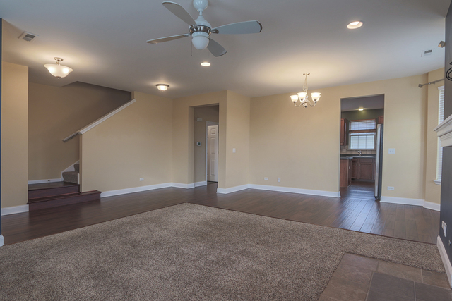 1240 Mariemont Road, Unit E Sugar Grove, IL 60554 - Photo 13 of 32 an empty room with wooden floor and windows