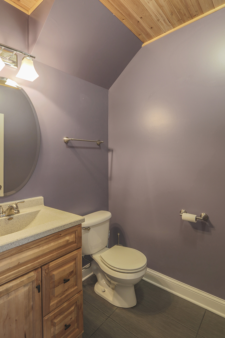 1240 Mariemont Road, Unit E Sugar Grove, IL 60554 - Photo 19 of 32 a bathroom with a toilet a sink and mirror