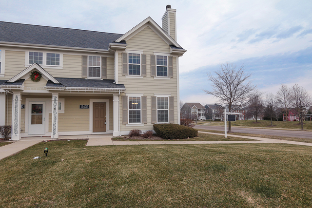 1240 Mariemont Road, Unit E Sugar Grove, IL 60554 - Photo 2 of 32 a front view of a house with garden