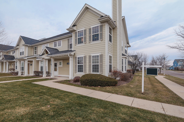 1240 Mariemont Road, Unit E Sugar Grove, IL 60554 - Photo 3 of 32 a front view of a house with a yard