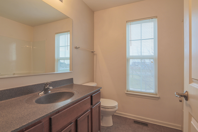 1240 Mariemont Road, Unit E Sugar Grove, IL 60554 - Photo 32 of 32 a bathroom with a sink and a toilet