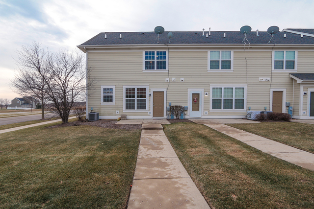 1240 Mariemont Road, Unit E Sugar Grove, IL 60554 - Photo 6 of 32 a front view of a house with yard