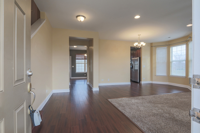 1240 Mariemont Road, Unit E Sugar Grove, IL 60554 - Photo 9 of 32 a view of a hallway with wooden floor