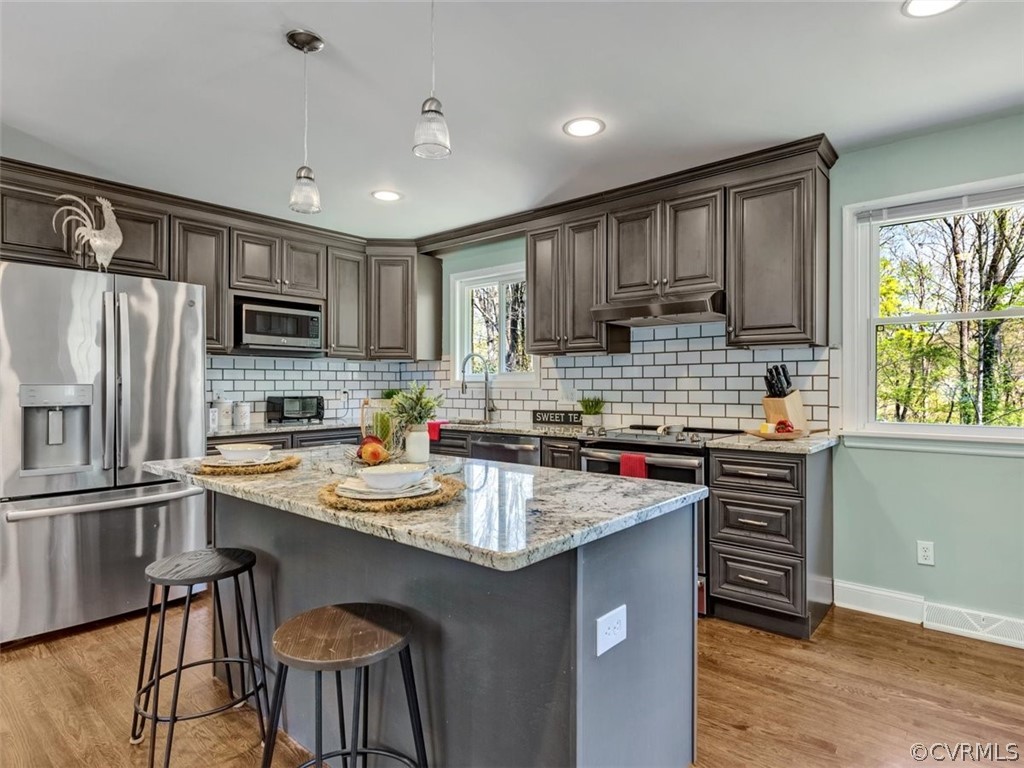 5331 Carteret Road Chesterfield, VA 23832 - Photo 8 of 27 a kitchen with kitchen island granite countertop a stove sink microwave and refrigerator