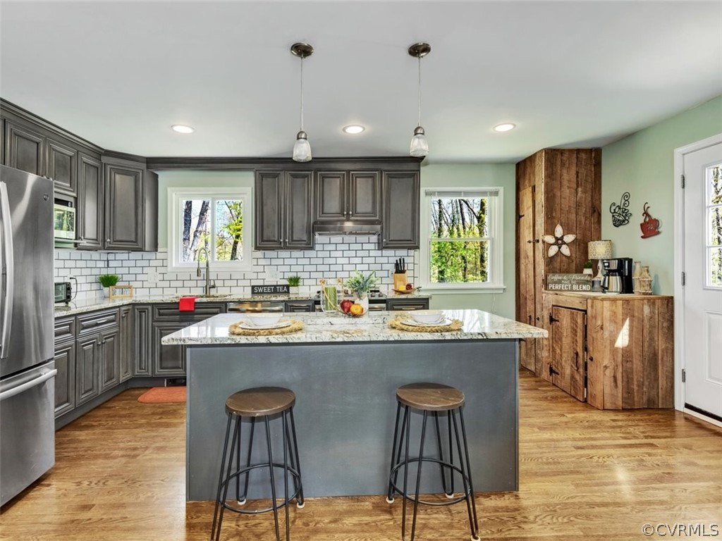 5331 Carteret Road Chesterfield, VA 23832 - Photo 9 of 27 a kitchen with kitchen island granite countertop wooden cabinets and refrigerator