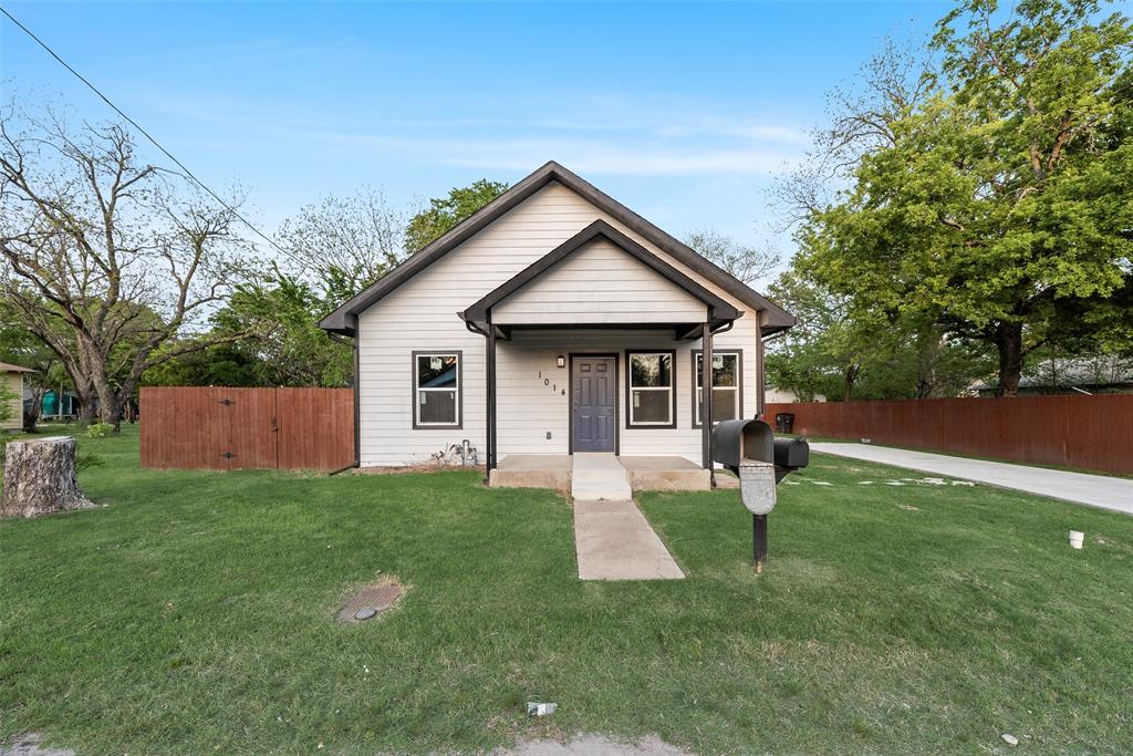 1014 Trinity Street Cleburne, TX 76031 - Photo 1 of 24 a front view of house with yard and green space