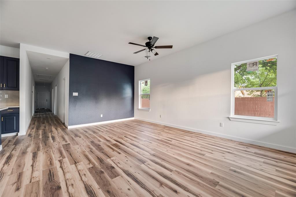 1014 Trinity Street Cleburne, TX 76031 - Photo 11 of 24 a view of empty room with wooden floor and fan