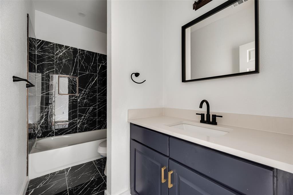 1014 Trinity Street Cleburne, TX 76031 - Photo 12 of 24 a bathroom with a sink and a mirror
