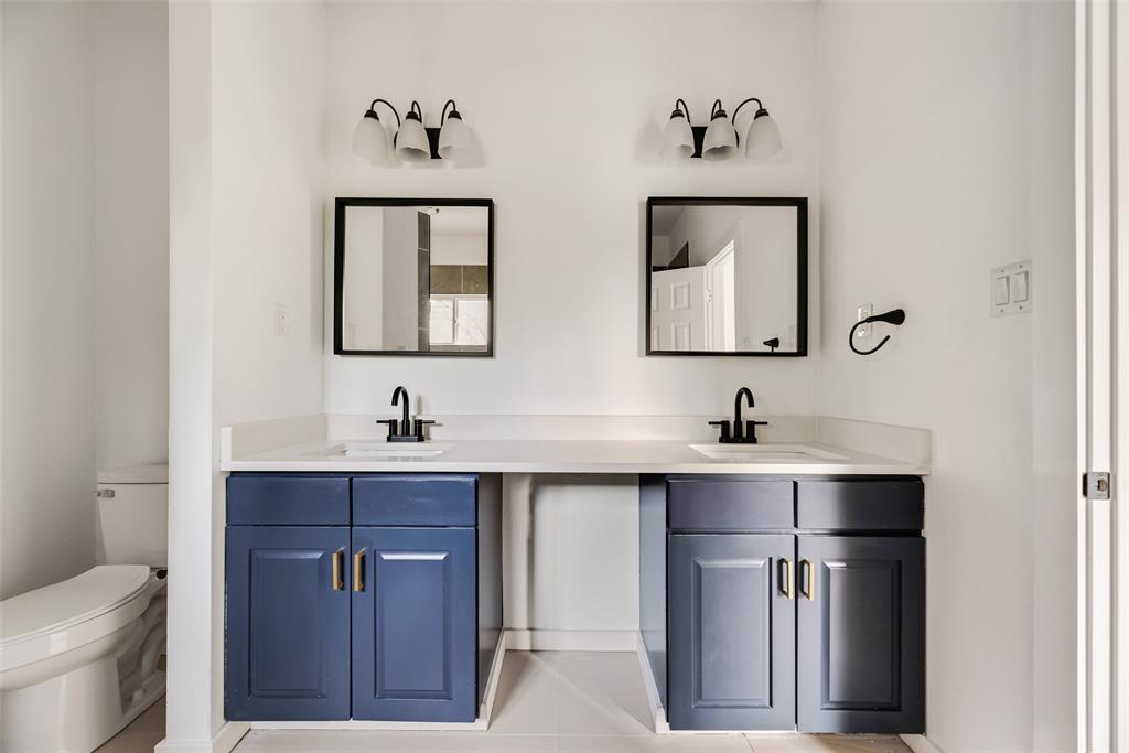 1014 Trinity Street Cleburne, TX 76031 - Photo 13 of 24 a bathroom with a sink and a toilet