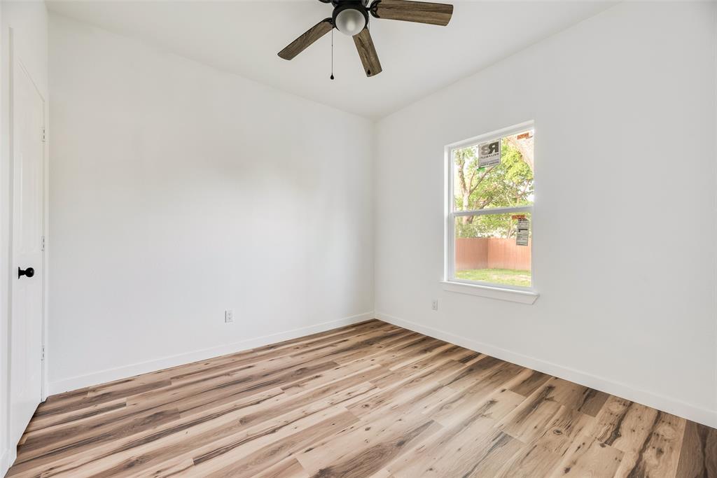 1014 Trinity Street Cleburne, TX 76031 - Photo 15 of 24 a view of empty room with ceiling fan
