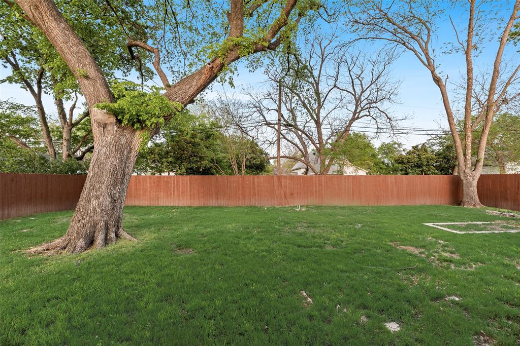 1014 Trinity Street Cleburne, TX 76031 - Photo 20 of 24 a backyard of a house with lots of green space