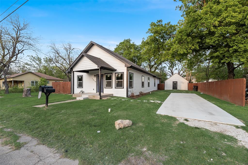 1014 Trinity Street Cleburne, TX 76031 - Photo 3 of 24 a front view of a house with a yard and trees