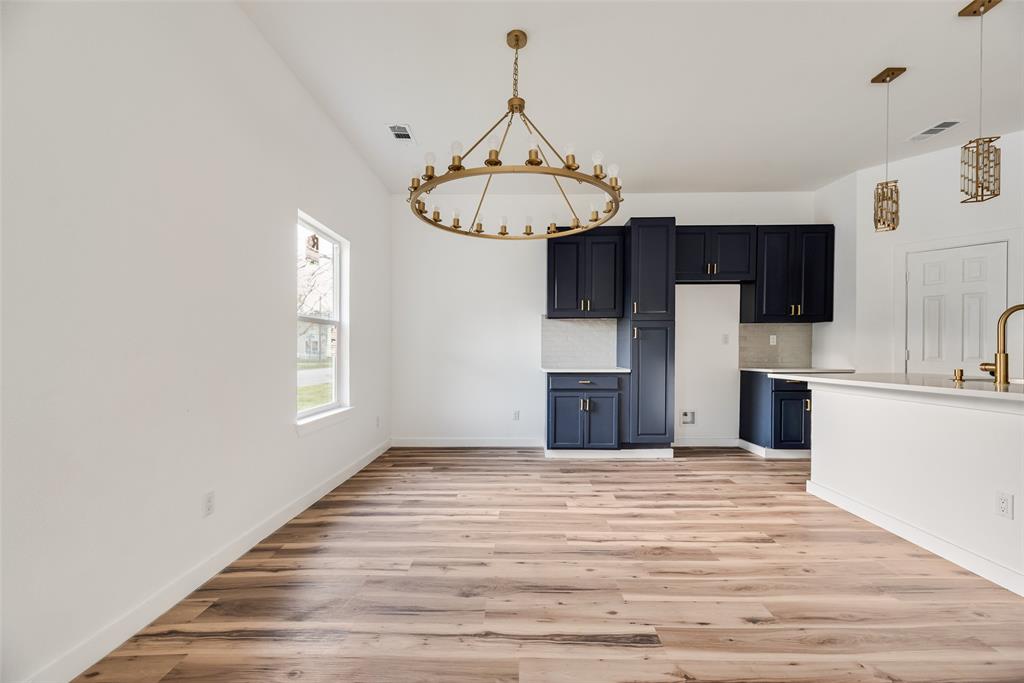 1014 Trinity Street Cleburne, TX 76031 - Photo 6 of 24 a view of a kitchen with a sink dishwasher and a microwave oven