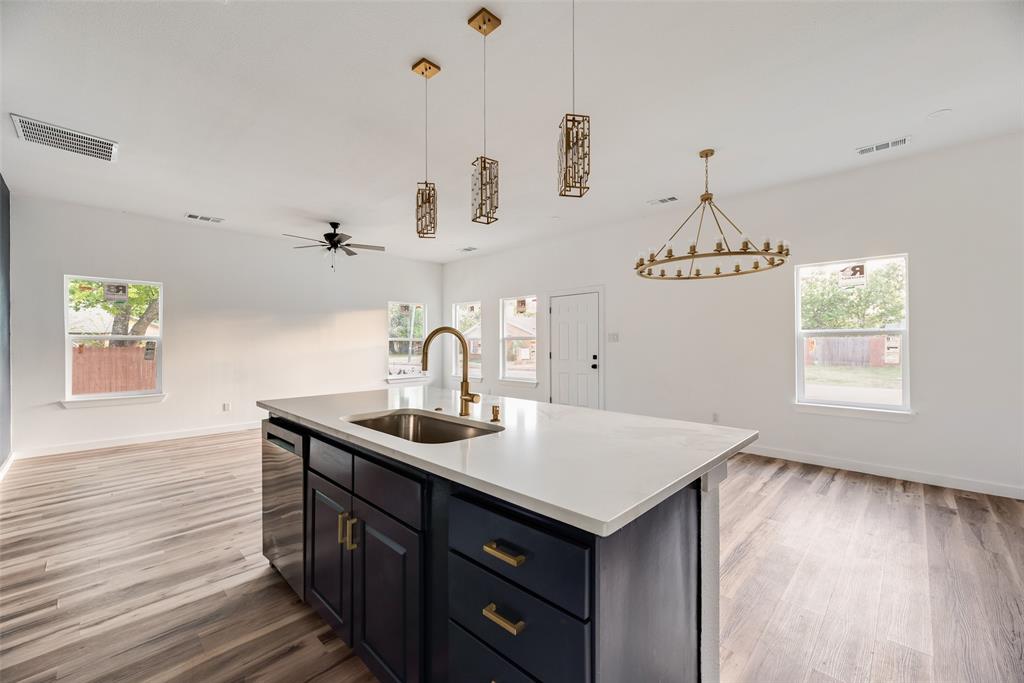 1014 Trinity Street Cleburne, TX 76031 - Photo 22 of 24 a kitchen with a sink a counter space and a window